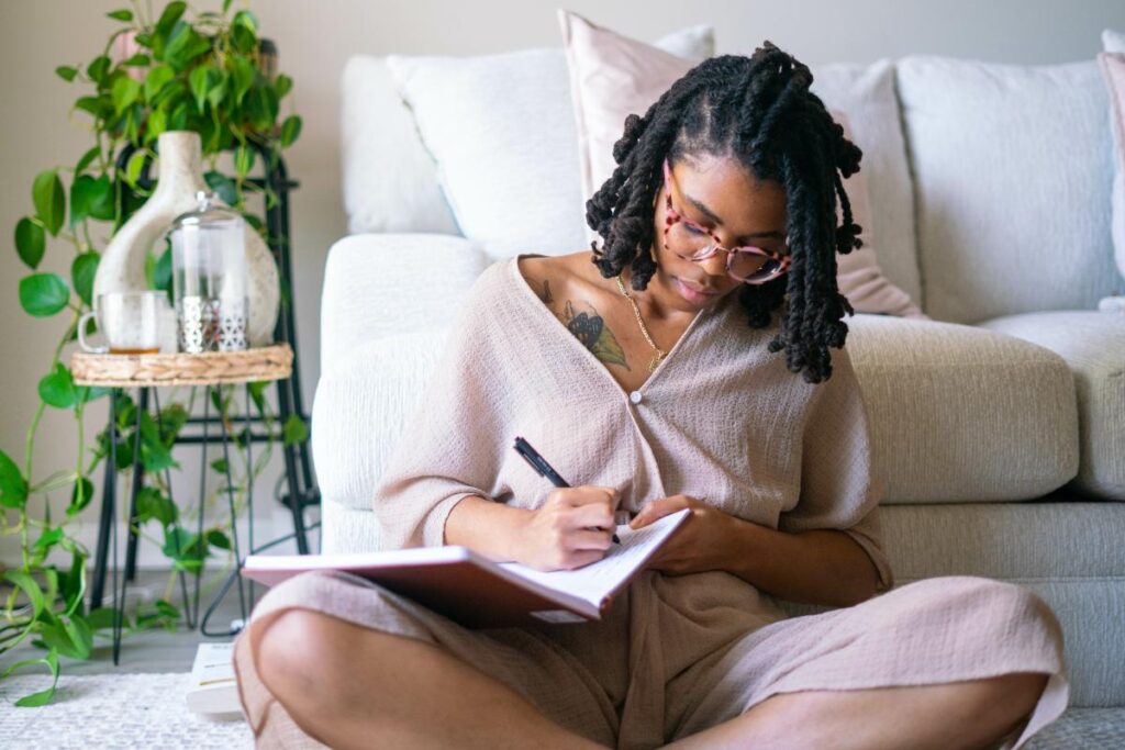 A woman jotting down sober living quotes