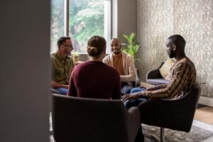 A group of people discussing halfway house rules