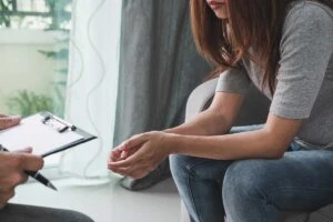 a woman in long term addiction recovery meets with her case manager