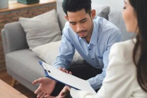 a man meets with his newly assigned case manager in addiction recovery